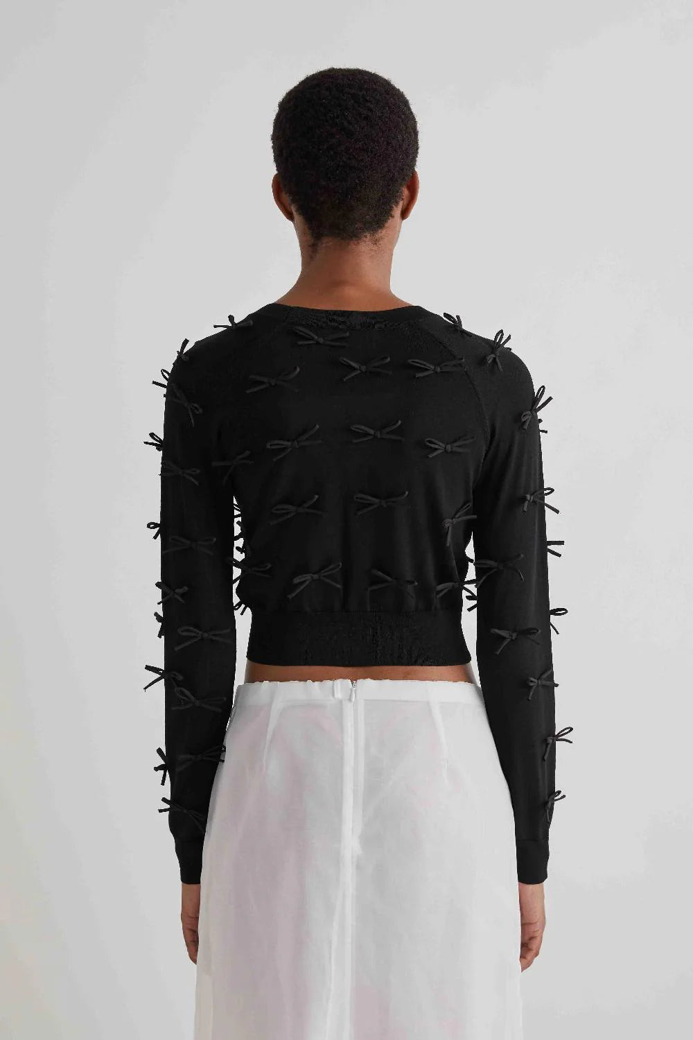 SHORT CARDIGAN WITH APPLIED BOWS