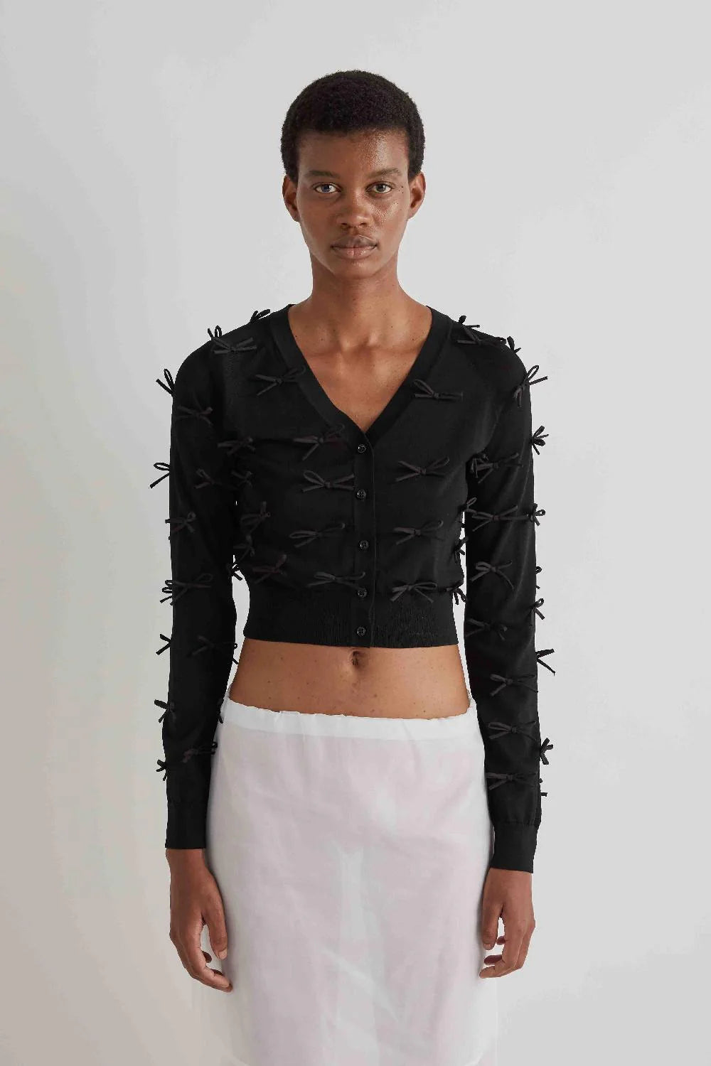 SHORT CARDIGAN WITH APPLIED BOWS